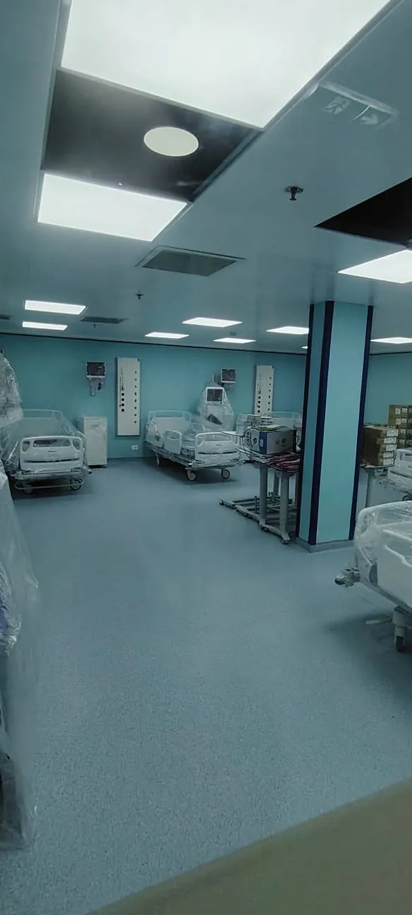 Hospital ward during fit-out with beds, bed head units and equipment being installed